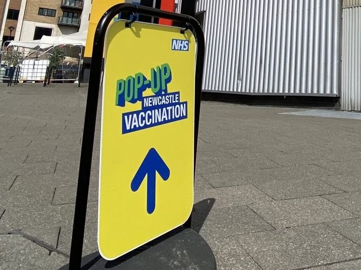 Sign directing people to the pop up vaccination centre at Newcastle's Life Science Centre