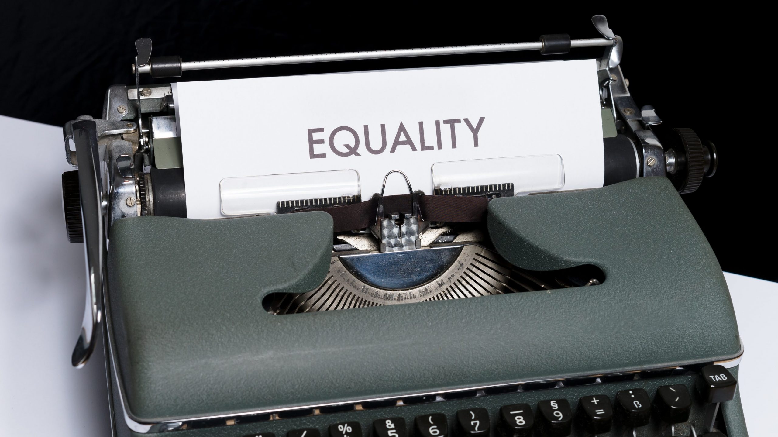 A typ writer with paper that reads equality. Photo by Markus Winkler on Unsplash