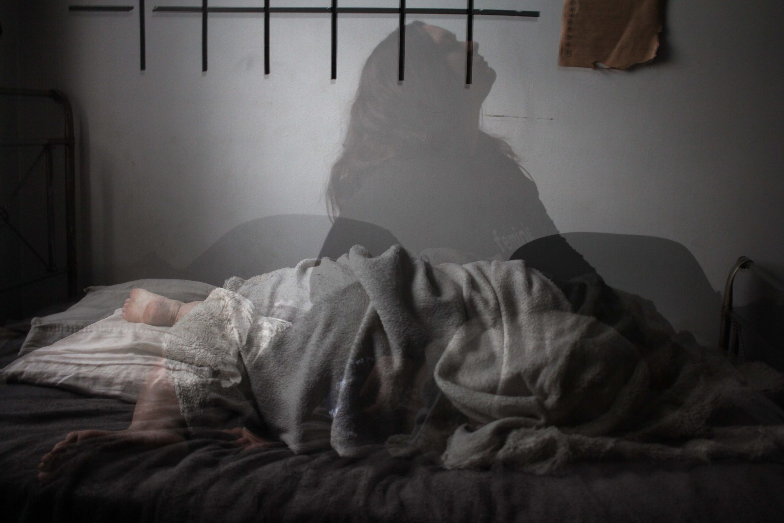 Shadow of a woman on a bed. Photo by Megan te Boekhorst on Unsplash