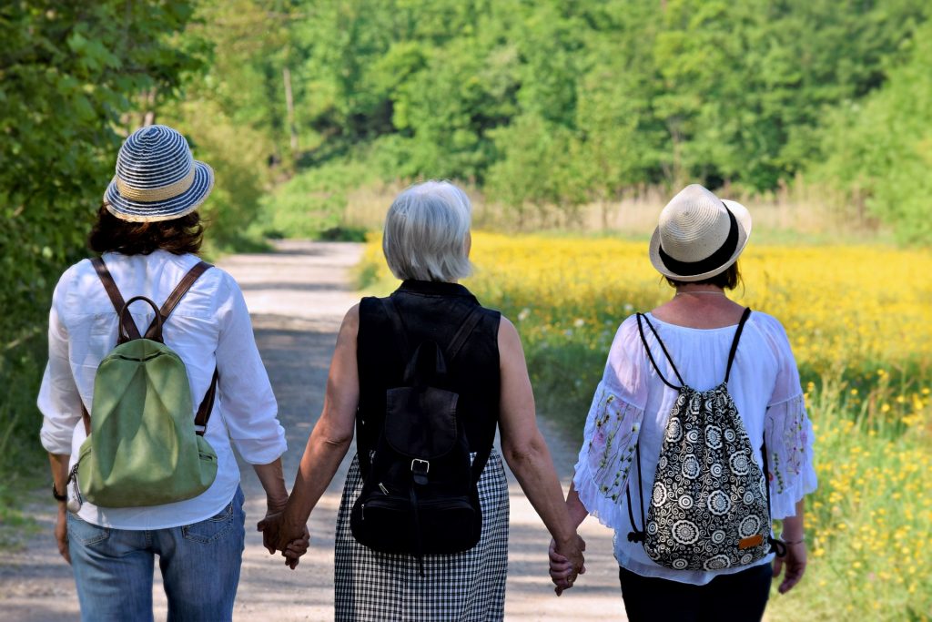 Three women walking together through a fieldImage by Silvia from Pixabay