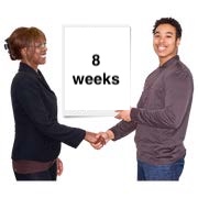 People shaking hands by a sign saying 8 weeks