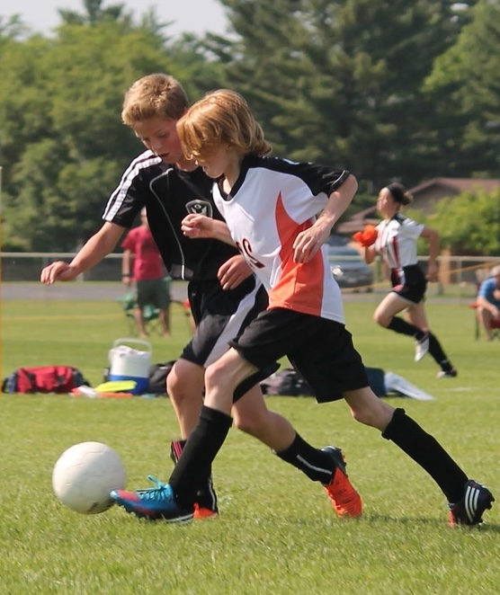 Boys playing football. Image by Josh Dick from Pixabay