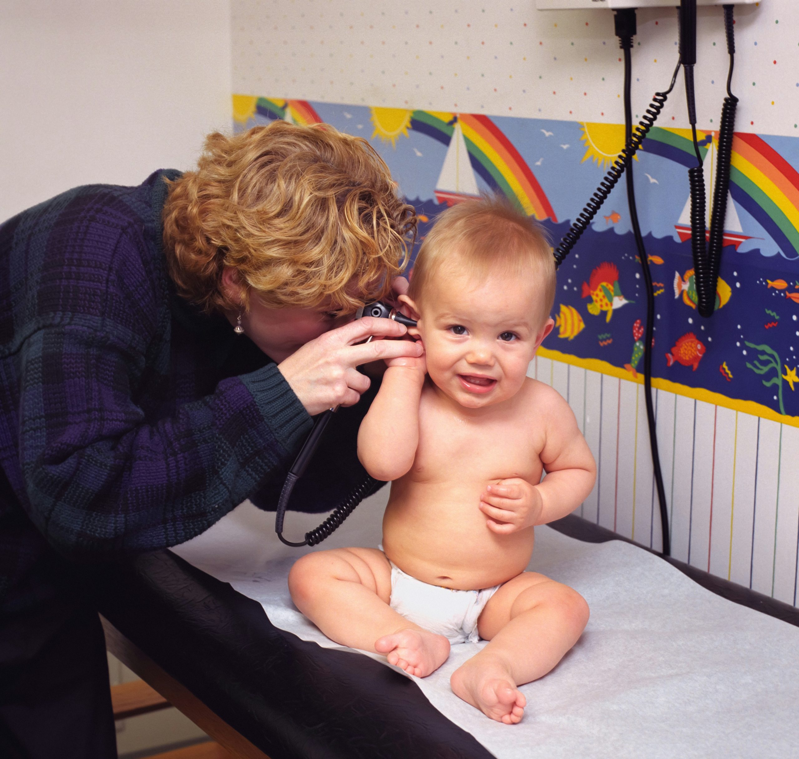 A paediatrician examining an infant at nine months of age. Image by CDC on Unsplash.com